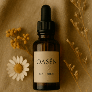 OASÉN herbal face oil bottle styled with dried flowers and a chamomile blossom, representing vegan skincare and emotional calm.